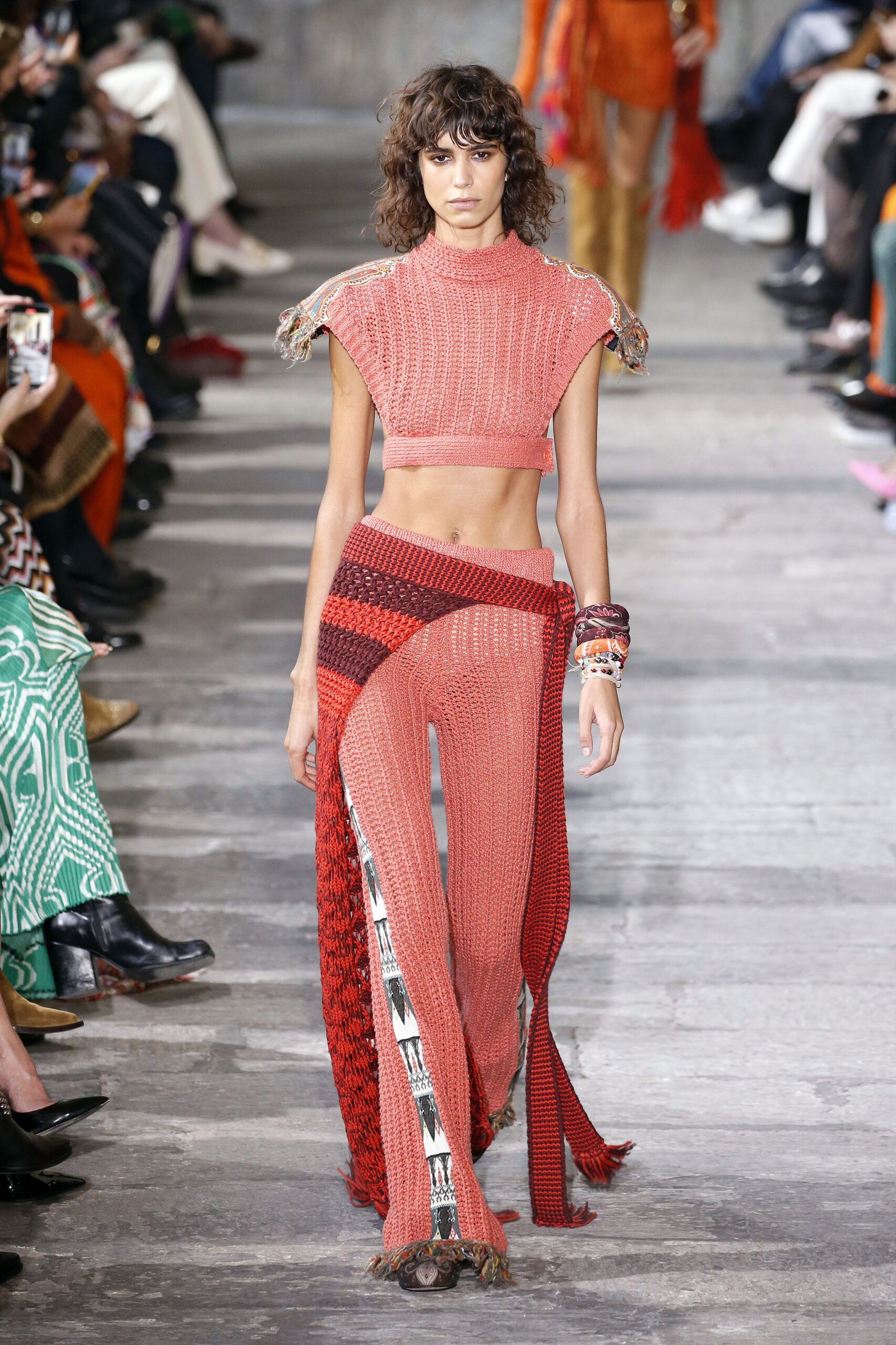 Egy modell egy Etro ruhában sétál a Milánói Fashion Weeken egy alcsony derekú nadrágban, és hasmuti felsőben