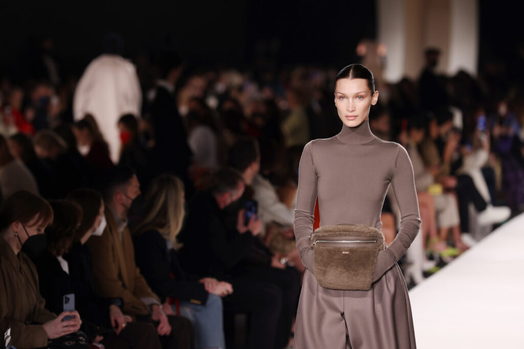 Egy modell egy barna, szőrmés Max Mara táskát tart a kezében