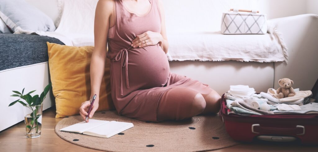egy várandós nő előkészíti a táskáját a szüléshez